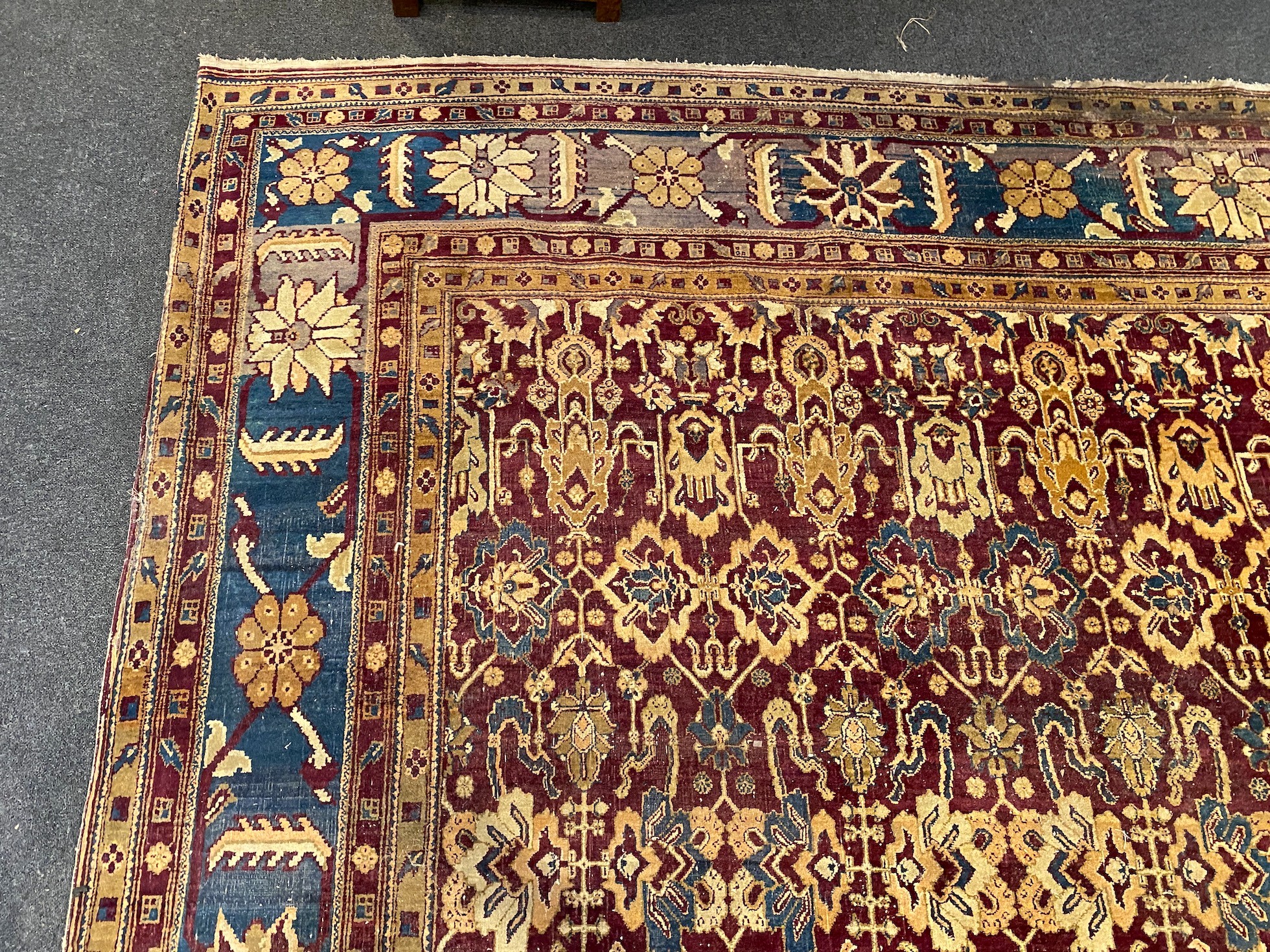 A large Sarouk purple ground carpet, approx. 20ft x 12ft. (cut in one area)
